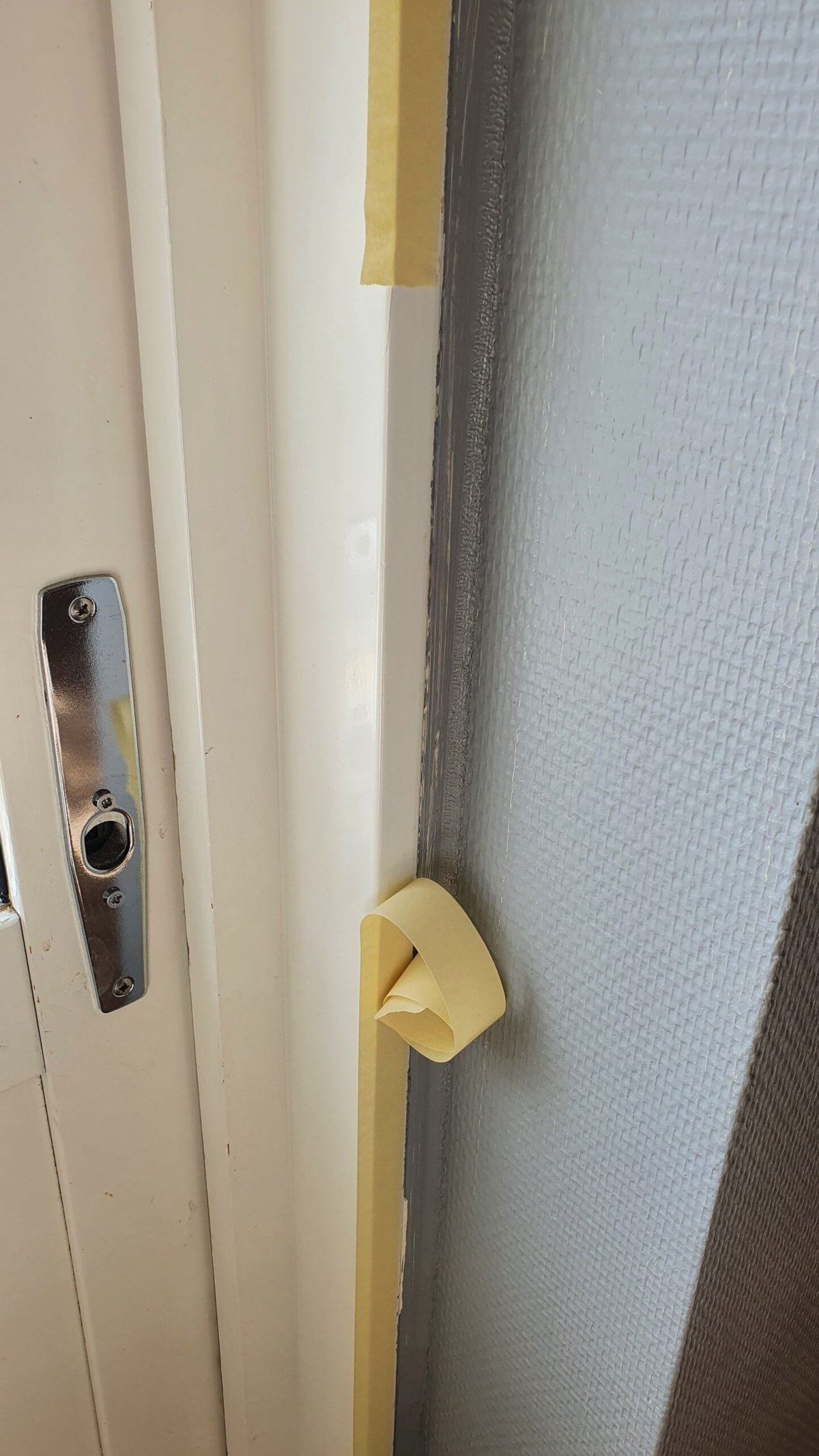 Low quality masking tape peeling off wall in small pieces the day after application