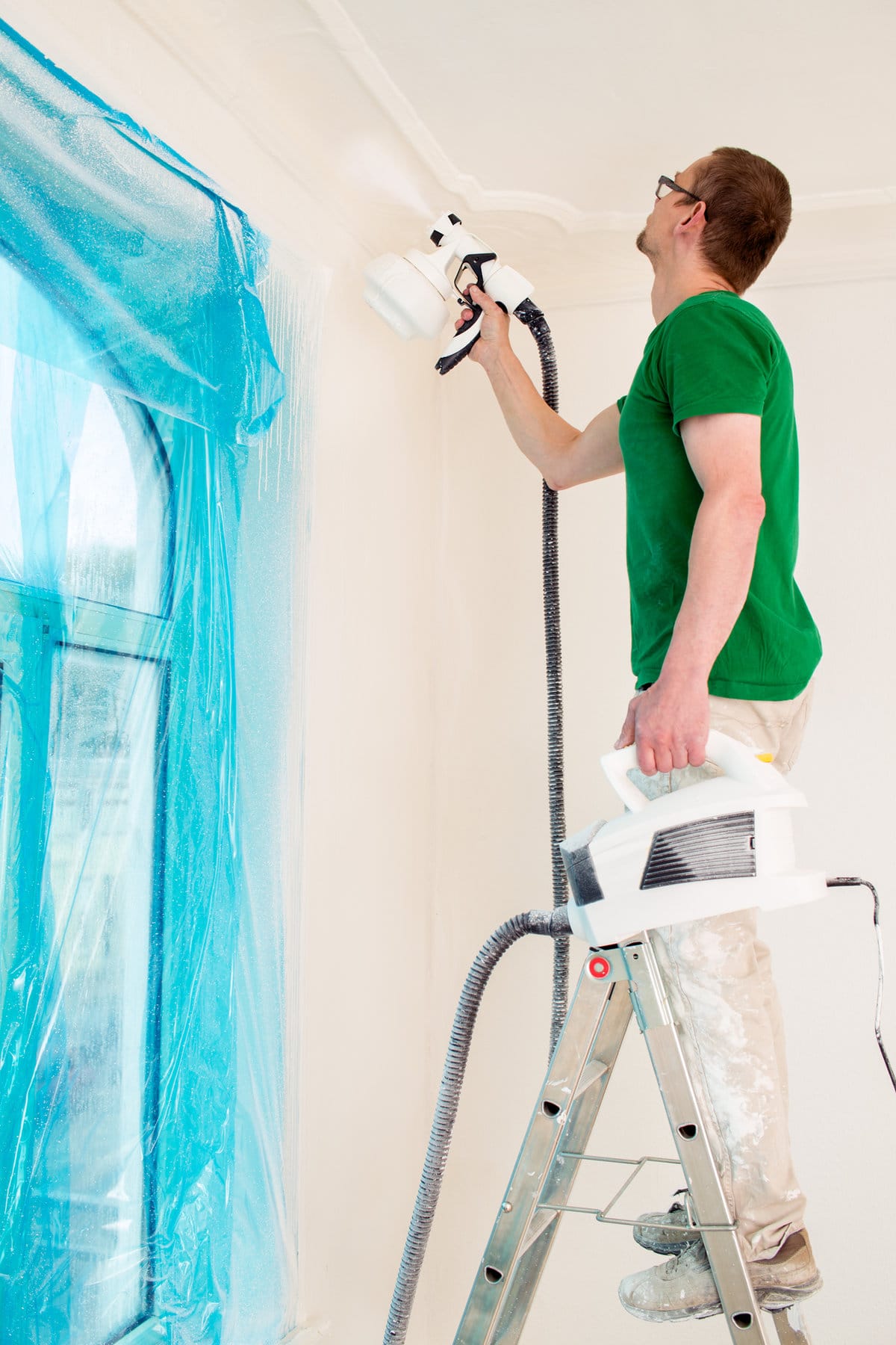 man spray painting